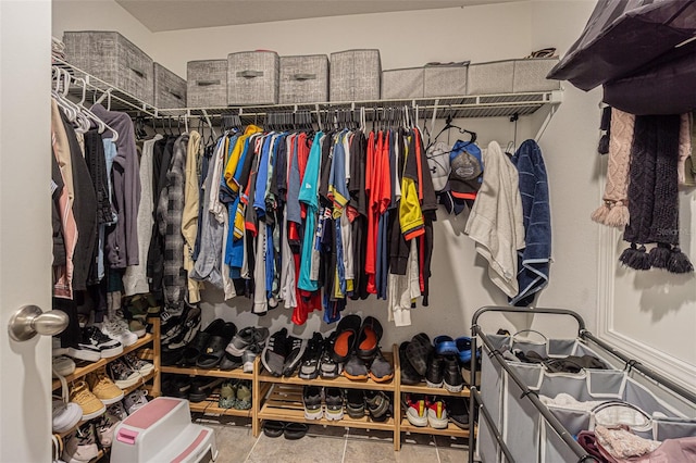 walk in closet with light tile patterned floors