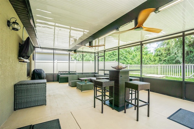 sunroom featuring ceiling fan