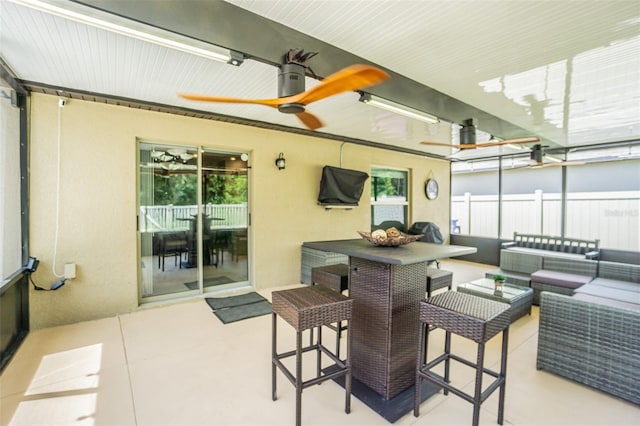 interior space with ceiling fan