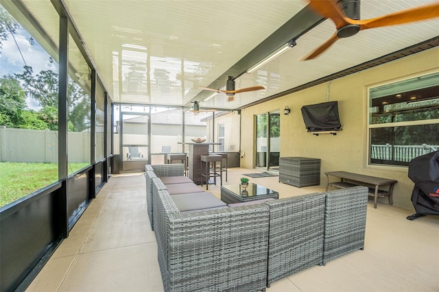 sunroom with ceiling fan