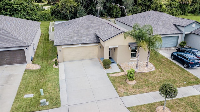 view of front of house with a front yard and a garage