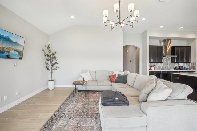 living room with vaulted ceiling, a chandelier, and light tile patterned flooring