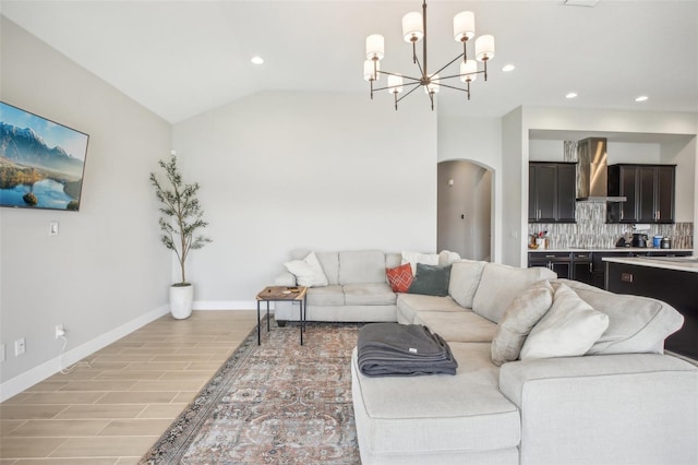 living area featuring arched walkways, lofted ceiling, recessed lighting, wood finish floors, and baseboards