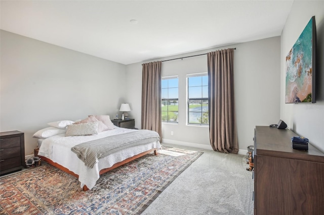 bedroom with baseboards and carpet flooring