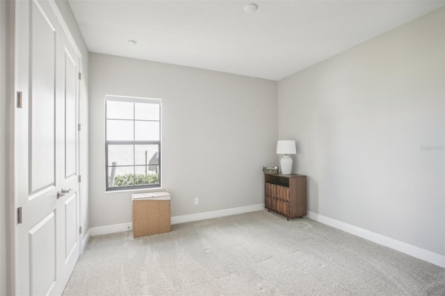 unfurnished bedroom with baseboards and light colored carpet