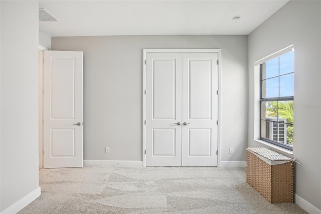 bedroom with a closet and light colored carpet