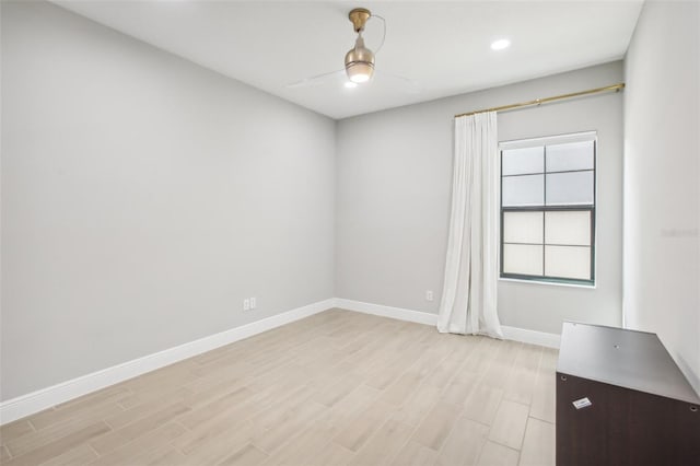 empty room with ceiling fan, recessed lighting, light wood-style flooring, and baseboards