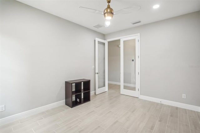 unfurnished room featuring french doors, ceiling fan, and light hardwood / wood-style floors