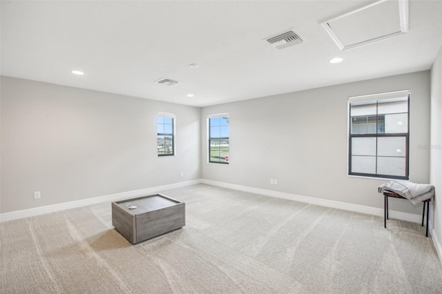 spare room featuring recessed lighting, light colored carpet, visible vents, baseboards, and attic access