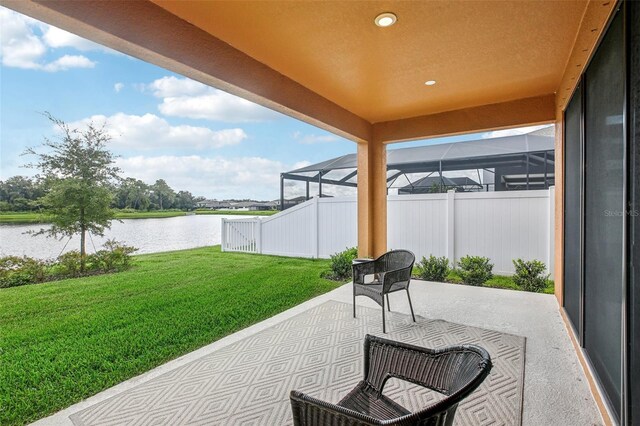 view of patio / terrace with a water view and a lanai