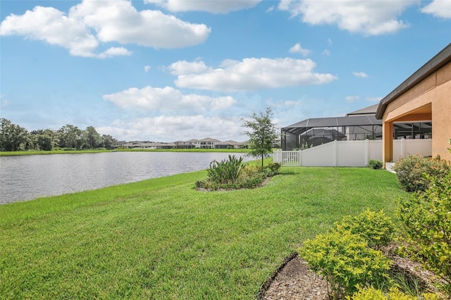 view of yard with a water view and fence
