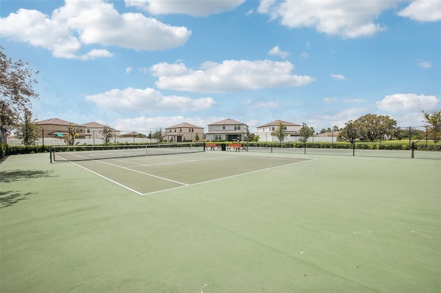 view of sport court with a residential view and fence