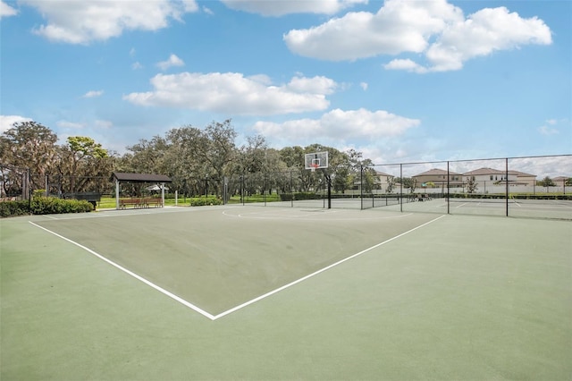 view of basketball court featuring community basketball court and fence