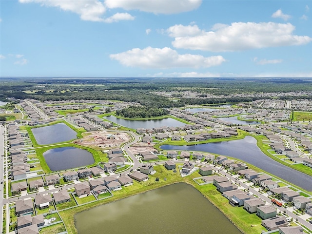 drone / aerial view featuring a residential view and a water view