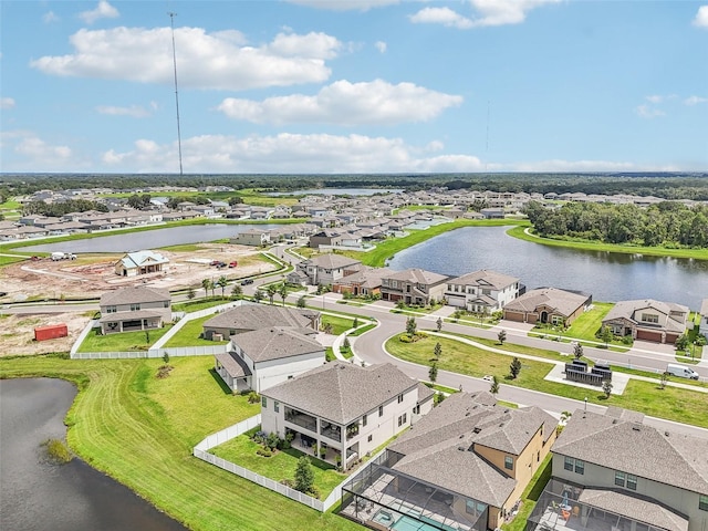 drone / aerial view featuring a water view and a residential view