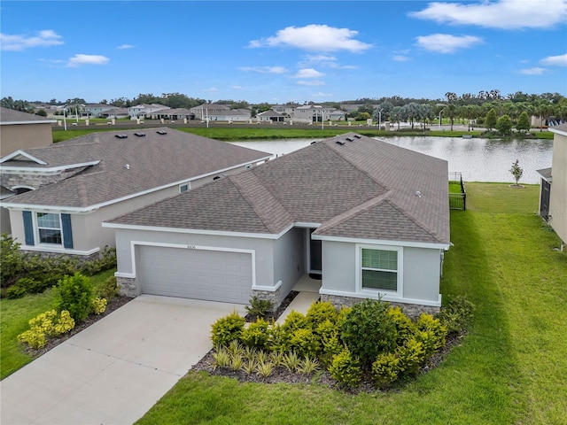 single story home with a garage, a water view, and a front lawn