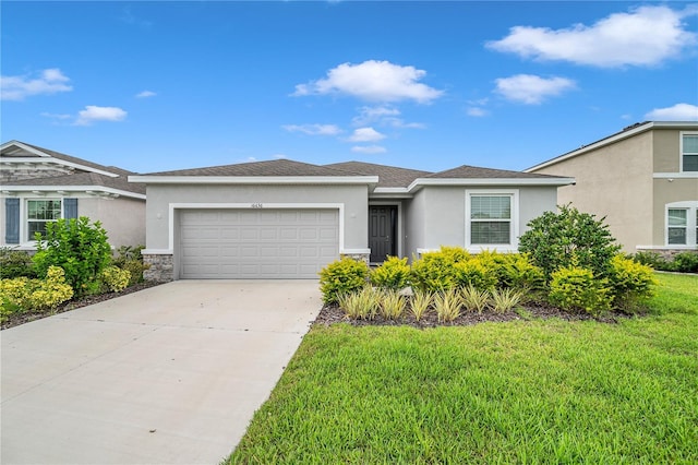 view of front of house featuring a garage and a front yard