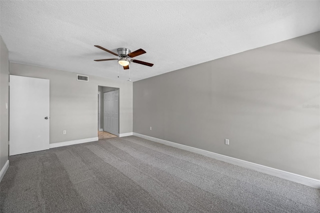 unfurnished bedroom with visible vents, baseboards, ceiling fan, carpet flooring, and a textured ceiling