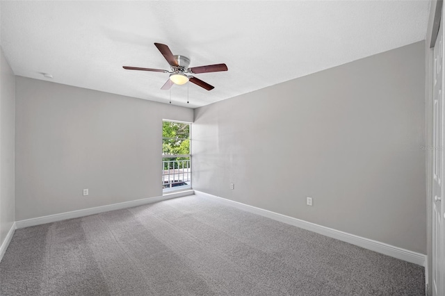 carpeted empty room with baseboards and ceiling fan