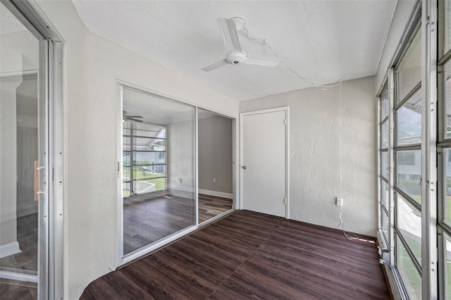 unfurnished sunroom featuring ceiling fan