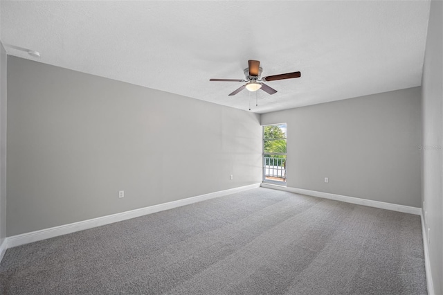 spare room featuring a textured ceiling, baseboards, ceiling fan, and carpet floors