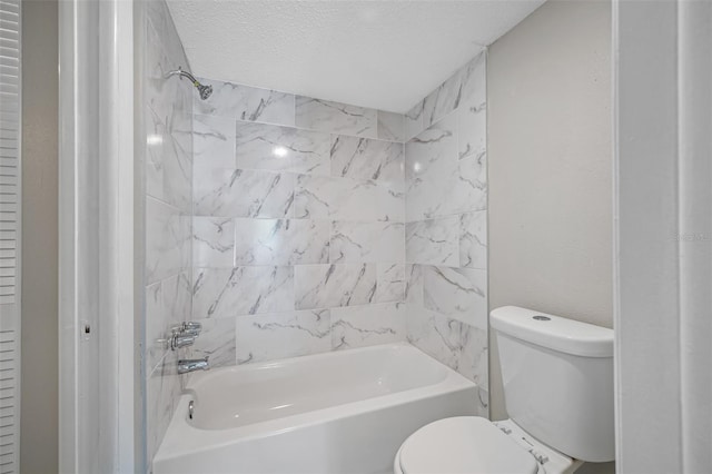 full bathroom with a textured ceiling, toilet, and washtub / shower combination