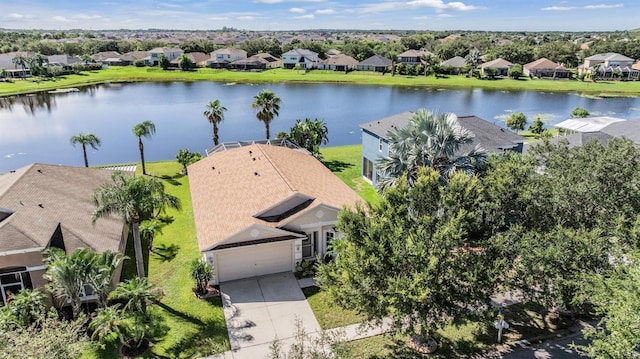 drone / aerial view with a water view and a residential view