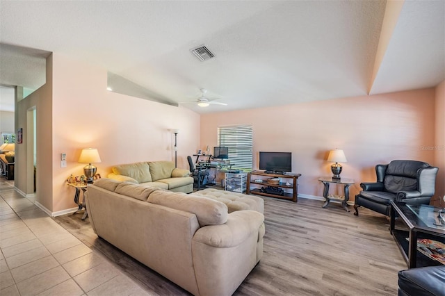 living room featuring ceiling fan and light hardwood / wood-style floors