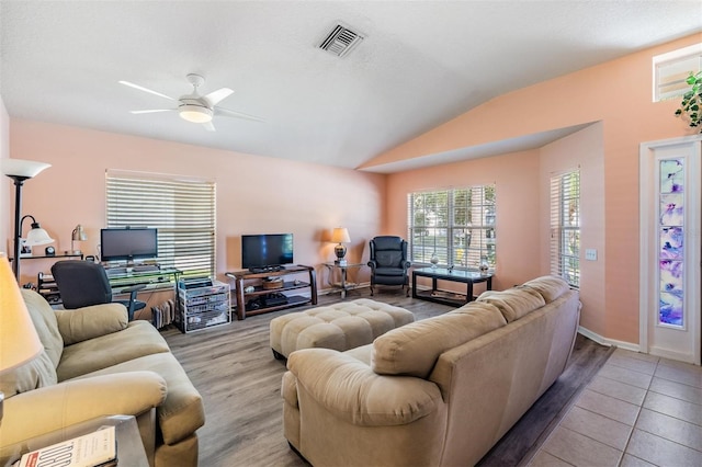 living room with lofted ceiling, ceiling fan, and light hardwood / wood-style floors