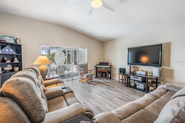 living room with lofted ceiling, ceiling fan, and light hardwood / wood-style flooring