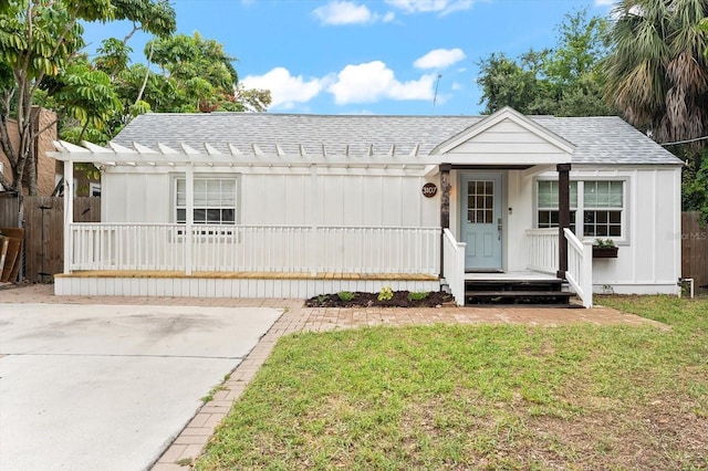 view of front of home with a porch and a front yard