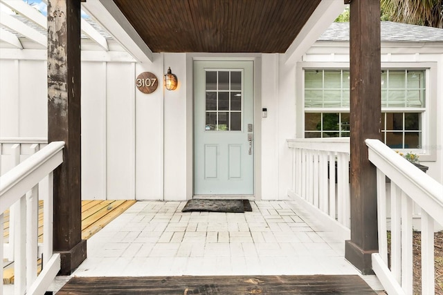 view of exterior entry with covered porch