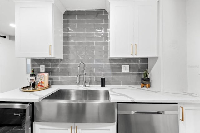 kitchen featuring backsplash, dishwasher, light stone countertops, and beverage cooler