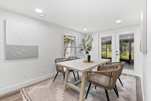 dining area featuring light wood-type flooring and french doors