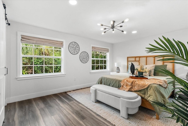 bedroom featuring dark wood-type flooring and an inviting chandelier