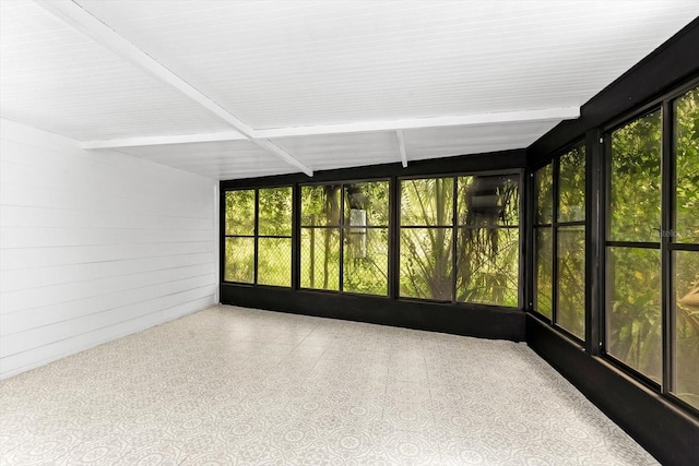 unfurnished sunroom with beamed ceiling