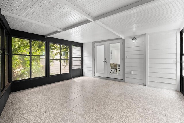 unfurnished sunroom with beamed ceiling and french doors