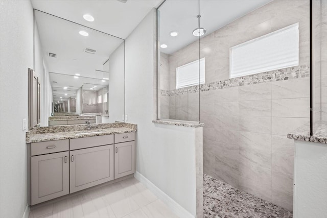 bathroom featuring vanity and a tile shower