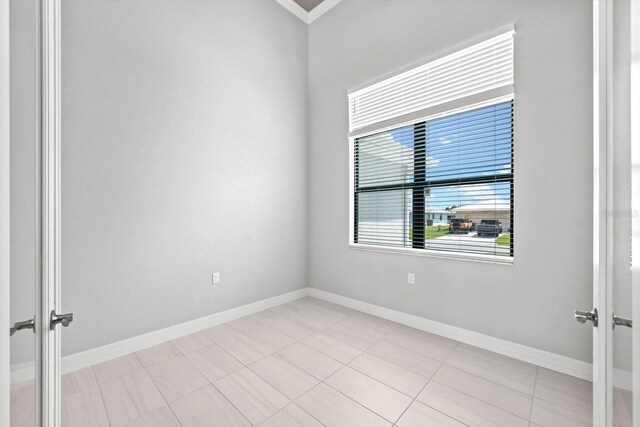 spare room with light tile patterned floors and french doors