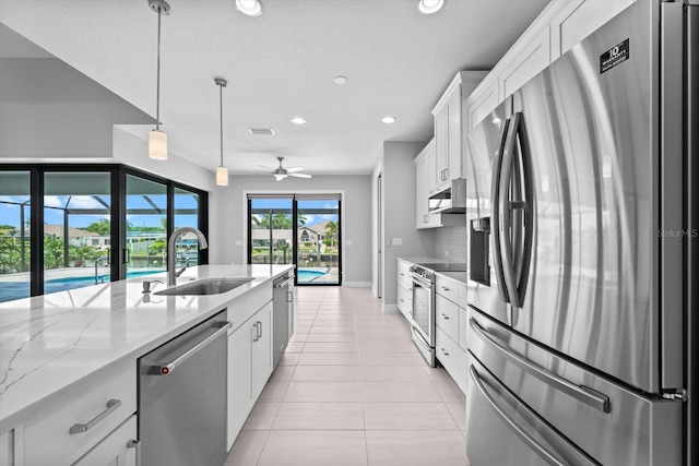 kitchen with white cabinetry, sink, ceiling fan, stainless steel appliances, and decorative light fixtures