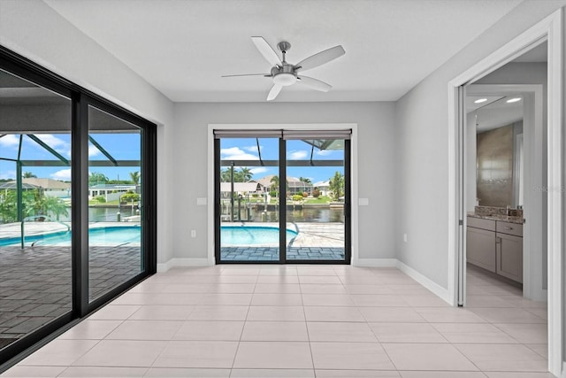 unfurnished room with ceiling fan and light tile patterned floors