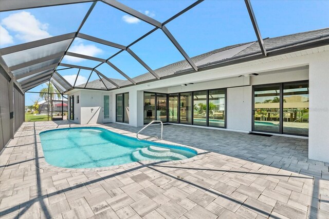 view of swimming pool with a lanai and a patio