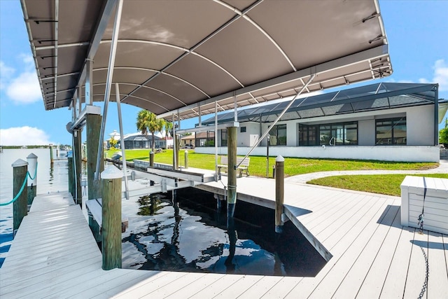 dock area featuring a lanai and a lawn