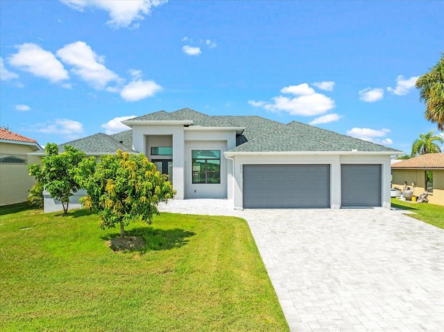 prairie-style home featuring a front lawn and a garage