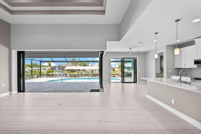 view of swimming pool with ceiling fan and sink