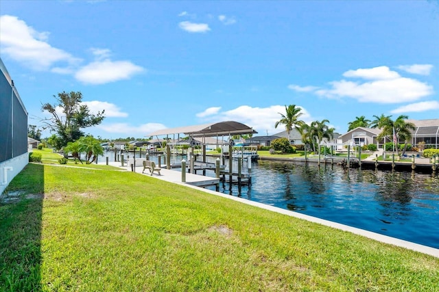 dock area featuring a lawn and a water view