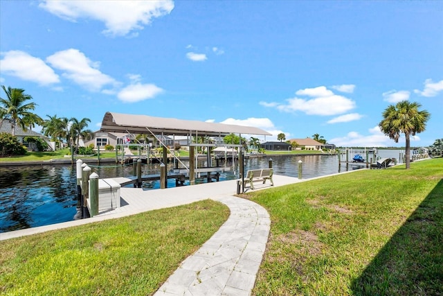 dock area featuring a lawn and a water view