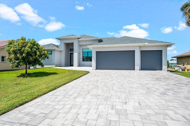 5217 Forbes Ter, Port Charlotte, FL 33981 - prairie-style house featuring decorative driveway, an attached garage, a front yard, and stucco siding