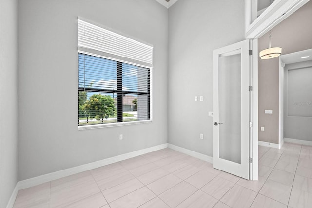 5217 Forbes Ter, Port Charlotte, FL 33981 - unfurnished room with light tile patterned floors, baseboards, and french doors