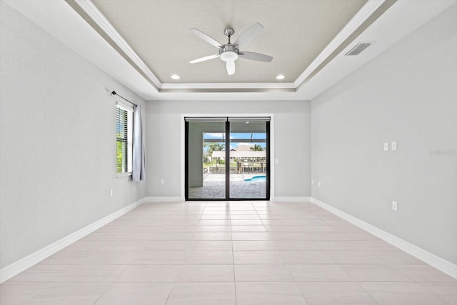 5217 Forbes Ter, Port Charlotte, FL 33981 - spare room with a tray ceiling, a ceiling fan, light tile patterned floors, baseboards, and recessed lighting
